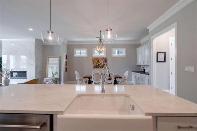 2010 Georgia Club Dr, Statham, GA 30666 - kitchen with crown molding, open floor plan, hanging light fixtures, white cabinetry, and light stone counters