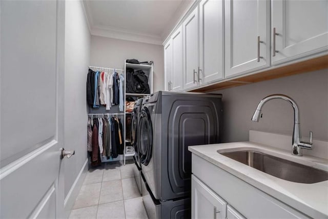 2010 Georgia Club Dr, Statham, GA 30666 - laundry room featuring cabinet space, ornamental molding, separate washer and dryer, and light tile patterned floors