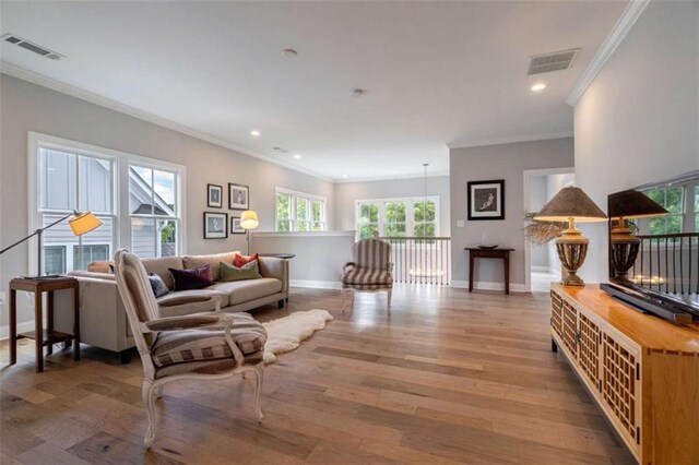 2010 Georgia Club Dr, Statham, GA 30666 - living room with healthy amount of natural light, ornamental molding, recessed lighting, and wood finished floors