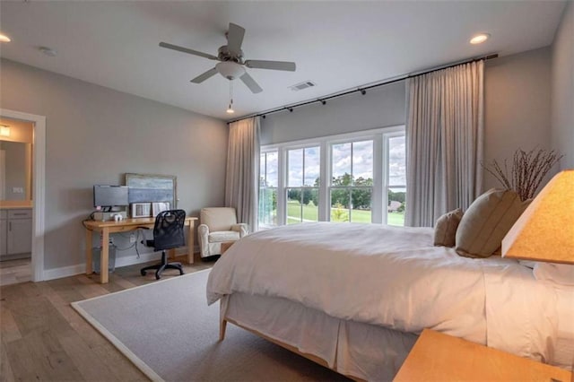 2010 Georgia Club Dr, Statham, GA 30666 - bedroom with wood finished floors, recessed lighting, connected bathroom, and a ceiling fan