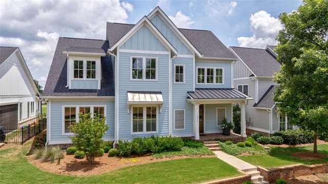 2010 Georgia Club Dr, Statham, GA 30666 - view of front of house featuring board and batten siding, roof with shingles, and a standing seam roof