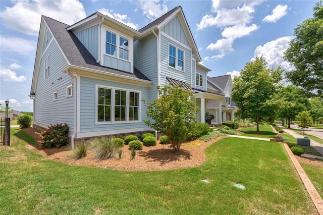 2010 Georgia Club Dr, Statham, GA 30666 - view of side of home with board and batten siding, a lawn, and roof with shingles