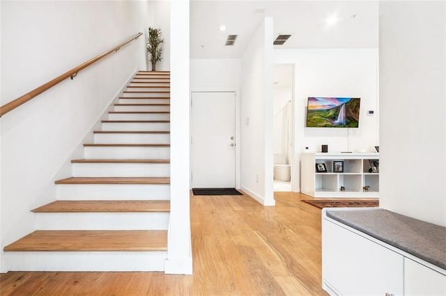 staircase with wood-type flooring