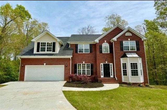 view of front of home with a garage and a front lawn