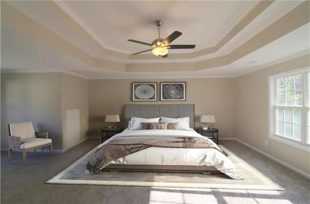 bedroom with a raised ceiling, ornamental molding, carpet, and ceiling fan