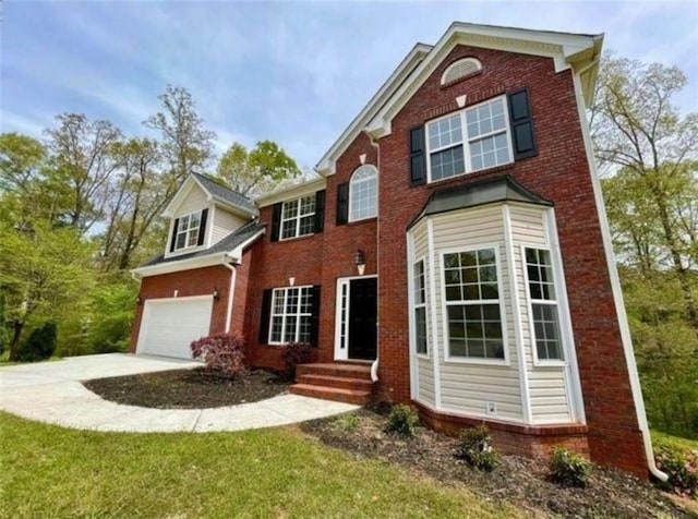 front of property featuring a garage and a front yard