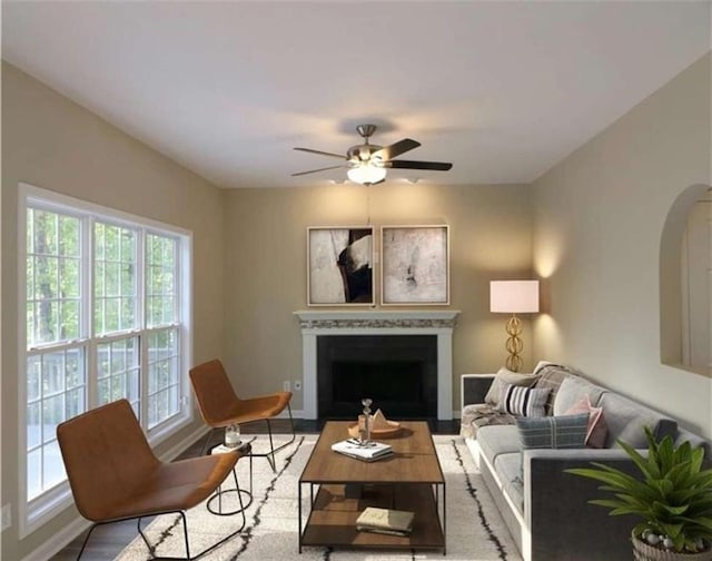 living room featuring ceiling fan and light wood-type flooring