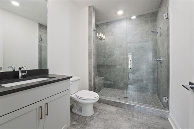 bathroom featuring tile patterned floors, vanity, an enclosed shower, and toilet