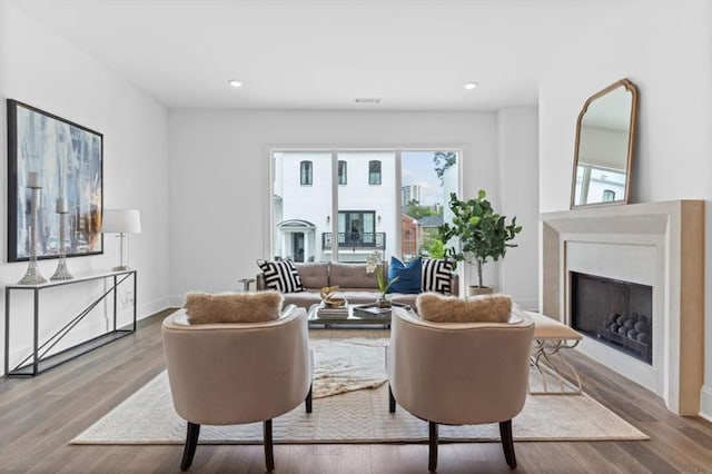 living room with a fireplace and hardwood / wood-style floors