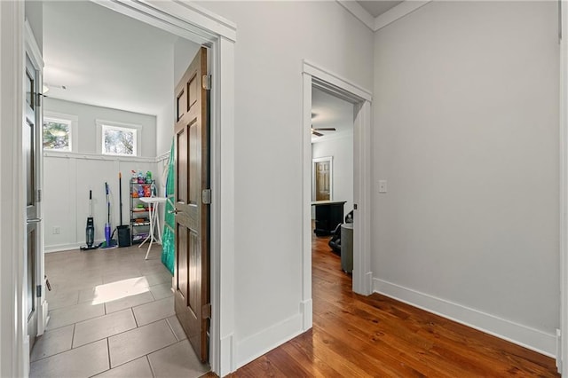 corridor featuring ornamental molding and hardwood / wood-style floors