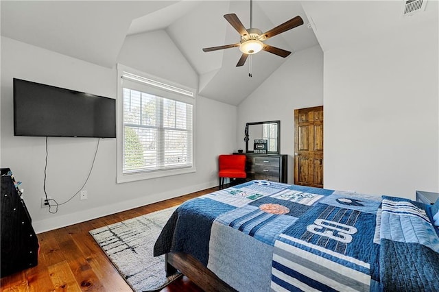 bedroom with dark hardwood / wood-style flooring, lofted ceiling, and ceiling fan