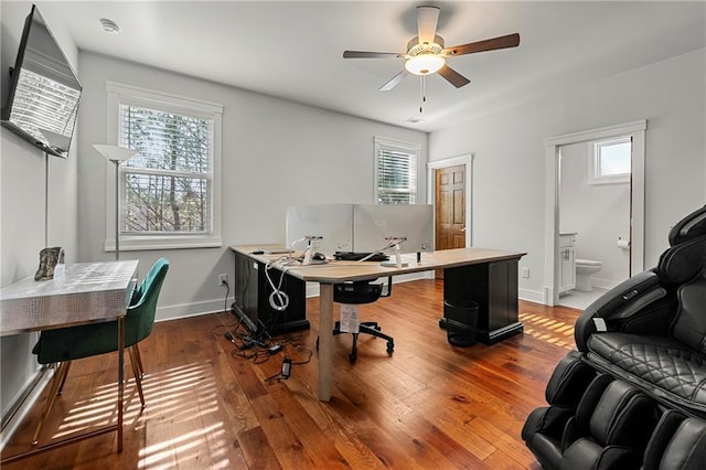 office featuring ceiling fan, wood-type flooring, and a wealth of natural light