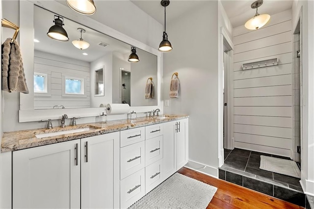 bathroom featuring vanity, hardwood / wood-style floors, and walk in shower