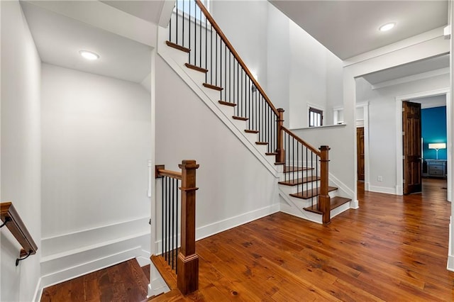 staircase featuring wood-type flooring