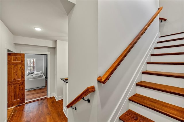 stairs featuring hardwood / wood-style floors