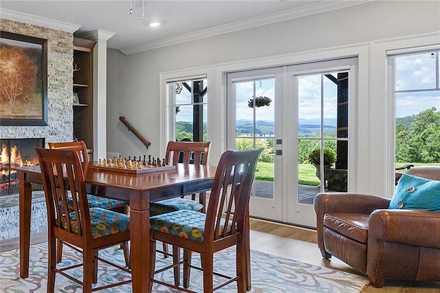 kitchen with appliances with stainless steel finishes, a sink, light wood-style floors, baseboards, and backsplash