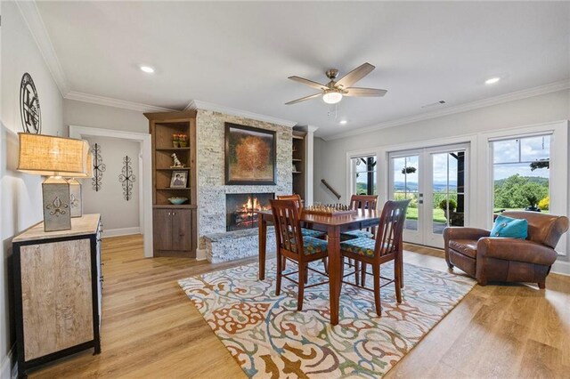 home theater featuring a ceiling fan, visible vents, crown molding, wood finished floors, and recessed lighting