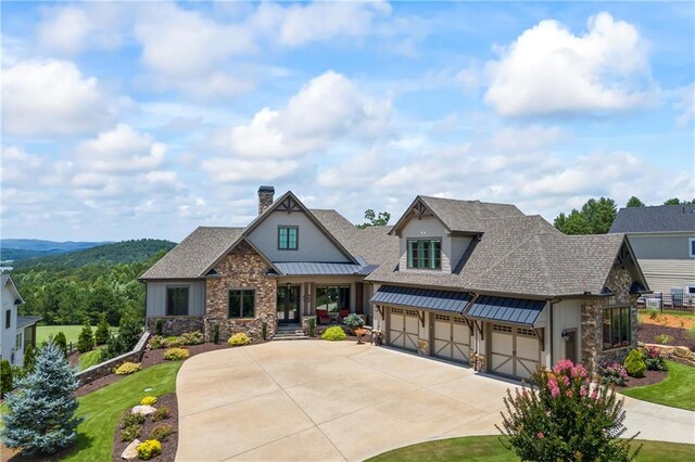 craftsman-style house with a garage, stone siding, roof with shingles, a chimney, and concrete driveway
