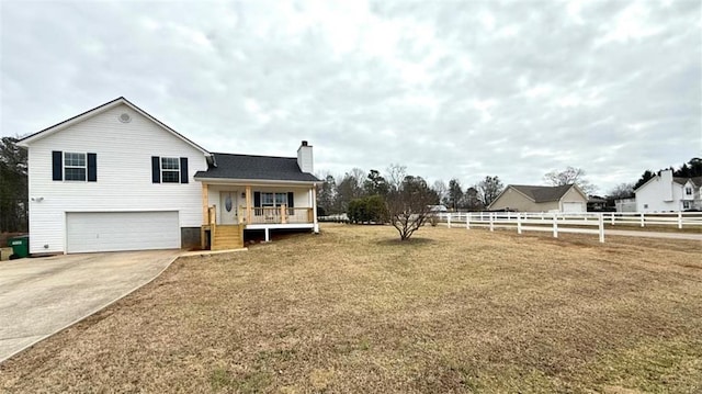 exterior space featuring a garage, covered porch, fence, a chimney, and driveway