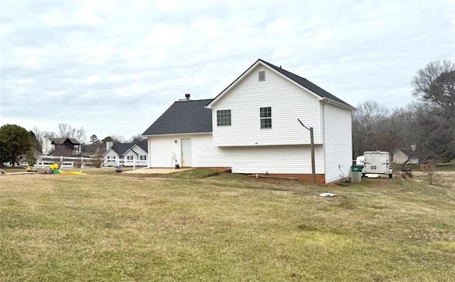 back of property featuring a patio and a yard