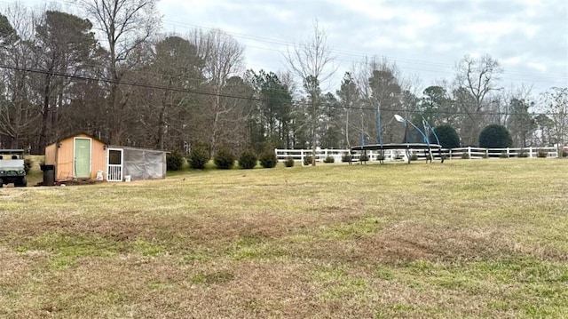 view of yard featuring an outbuilding and fence