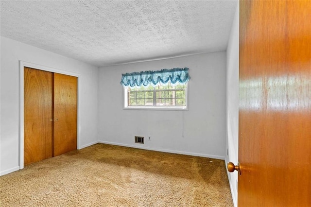900 Fleetwood Cir, Atlanta, GA 30311 - unfurnished bedroom with carpet flooring, a closet, a textured ceiling, and baseboards