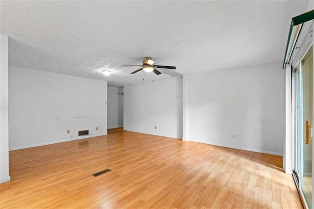 900 Fleetwood Cir, Atlanta, GA 30311 - empty room with light wood-style floors, a ceiling fan, a textured ceiling, and baseboards