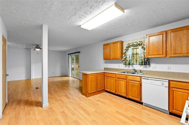 900 Fleetwood Cir, Atlanta, GA 30311 - kitchen featuring white dishwasher, a sink, a peninsula, light wood finished floors, and a textured ceiling