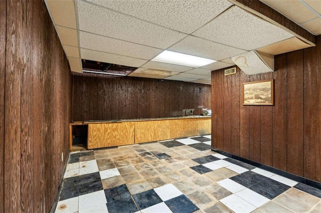 900 Fleetwood Cir, Atlanta, GA 30311 - finished basement featuring wooden walls, a paneled ceiling, and tile patterned floors