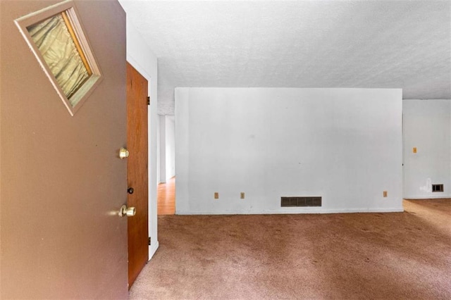 900 Fleetwood Cir, Atlanta, GA 30311 - unfurnished living room featuring carpet flooring and a textured ceiling