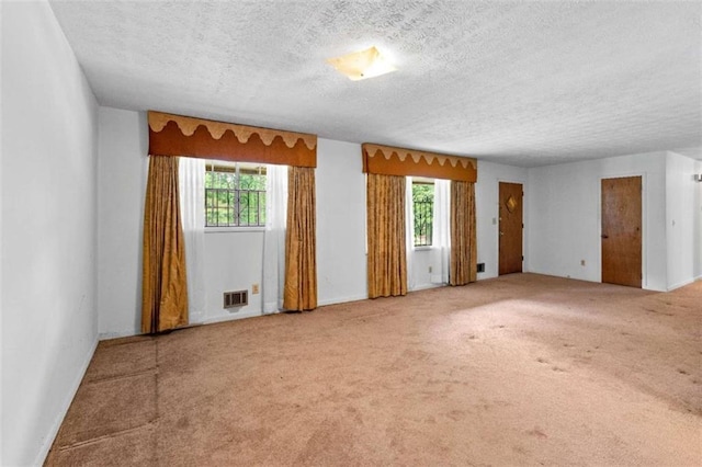 900 Fleetwood Cir, Atlanta, GA 30311 - empty room featuring a textured ceiling, plenty of natural light, carpet flooring, and baseboards