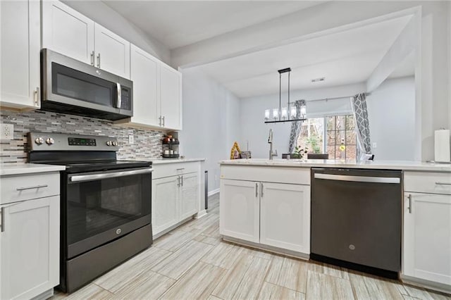 545 Windstone Trl, Alpharetta, GA 30004 - kitchen featuring stainless steel appliances, a sink, decorative backsplash, and white cabinets