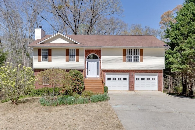 41 Pebble Ct, Hoschton, GA 30548 - raised ranch featuring a chimney, a garage, brick siding, and concrete driveway
