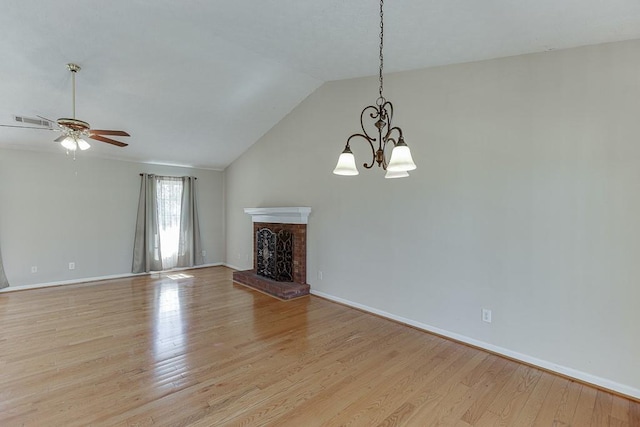 41 Pebble Ct, Hoschton, GA 30548 - unfurnished living room with visible vents, baseboards, lofted ceiling, light wood-type flooring, and ceiling fan with notable chandelier
