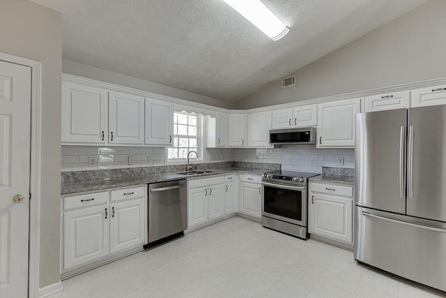 41 Pebble Ct, Hoschton, GA 30548 - kitchen with white cabinetry, a sink, stone countertops, visible vents, and appliances with stainless steel finishes