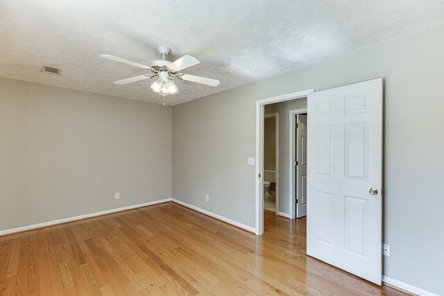 41 Pebble Ct, Hoschton, GA 30548 - unfurnished room with light wood finished floors, a textured ceiling, and a ceiling fan