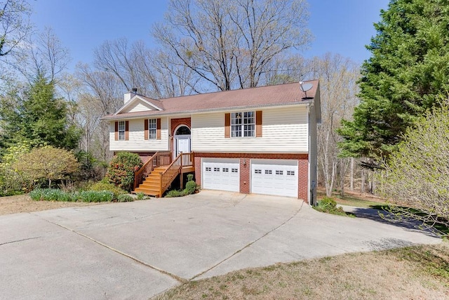 41 Pebble Ct, Hoschton, GA 30548 - bi-level home with a chimney, a garage, brick siding, and concrete driveway