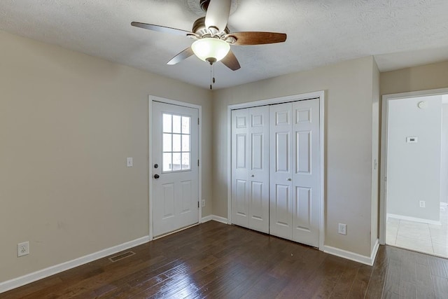 41 Pebble Ct, Hoschton, GA 30548 - foyer entrance with hardwood / wood-style flooring, a ceiling fan, a textured ceiling, baseboards, and visible vents