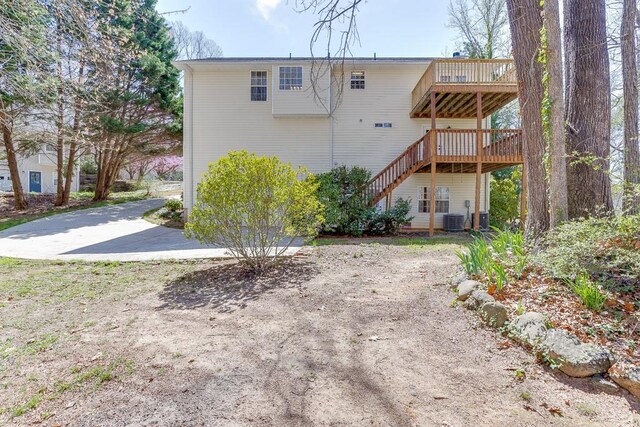 41 Pebble Ct, Hoschton, GA 30548 - back of house featuring a wooden deck and stairway