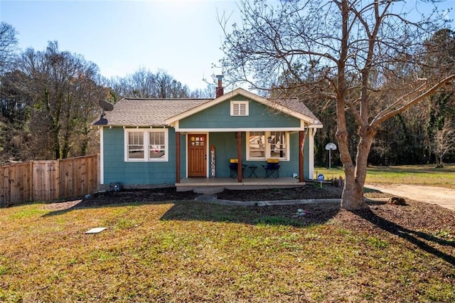 bungalow-style house featuring a porch and a front lawn