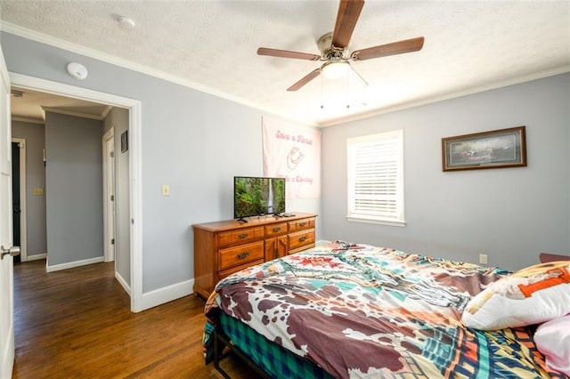 bedroom with crown molding, hardwood / wood-style floors, a textured ceiling, and ceiling fan