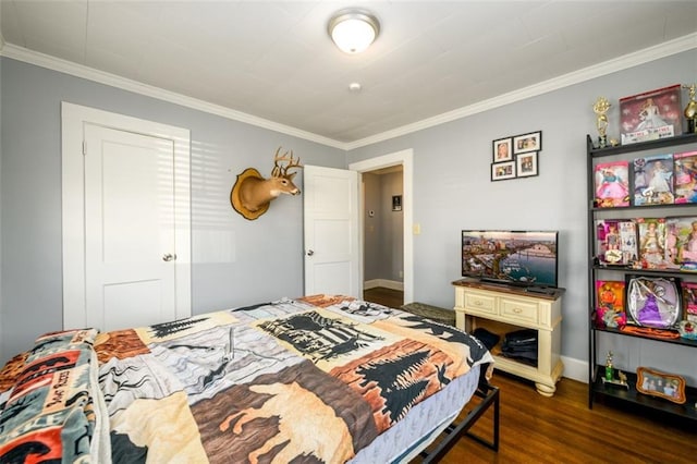 bedroom with dark hardwood / wood-style floors and ornamental molding