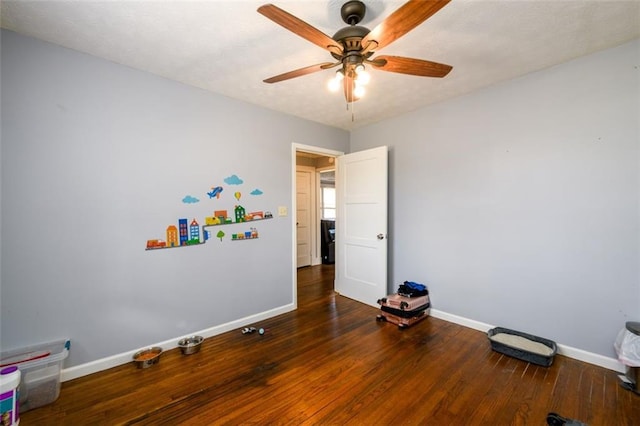 interior space with ceiling fan and dark hardwood / wood-style flooring