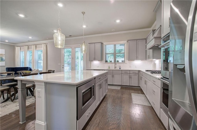 2657 Cedar Pine Way, Atlanta, GA 30360 - kitchen with stainless steel appliances, gray cabinets, dark wood-type flooring, crown molding, and a center island