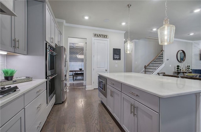2657 Cedar Pine Way, Atlanta, GA 30360 - kitchen featuring gray cabinets, crown molding, stainless steel appliances, a center island, and dark wood-type flooring