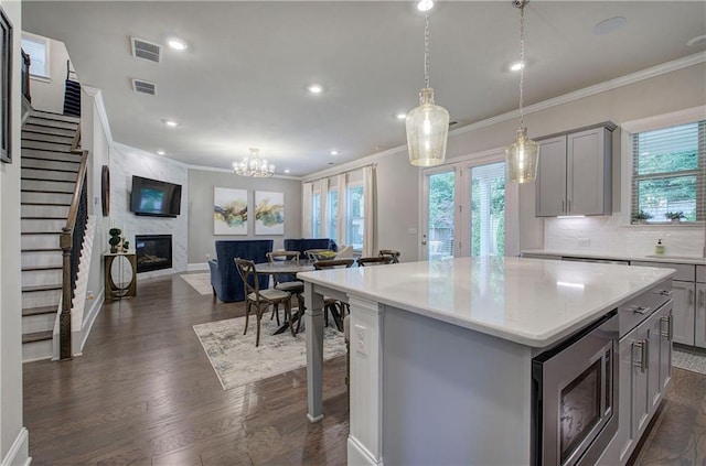2657 Cedar Pine Way, Atlanta, GA 30360 - kitchen with gray cabinets, stainless steel microwave, ornamental molding, healthy amount of natural light, and open floor plan