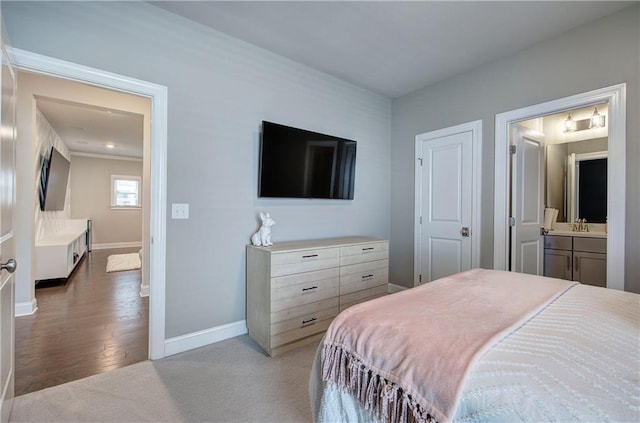 2657 Cedar Pine Way, Atlanta, GA 30360 - carpeted bedroom featuring a sink, baseboards, ensuite bath, and wood finished floors