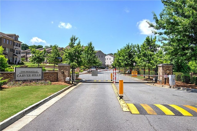 2657 Cedar Pine Way, Atlanta, GA 30360 - view of asphalt road with a gate, curbs, a gated entry, and a residential view