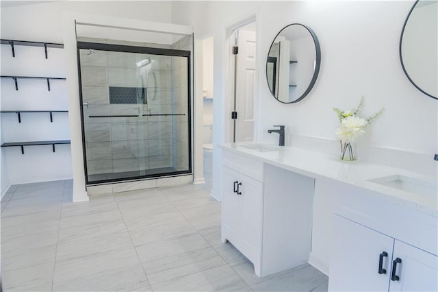 bathroom with vanity, toilet, and walk in shower