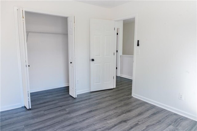 hallway with dark hardwood / wood-style flooring and a healthy amount of sunlight